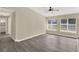 Bright living room with hardwood floors, large windows and a ceiling fan at 3 Trophy Ln, Kissimmee, FL 34759