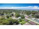 An aerial view of the neighborhood showcasing lush greenery and water views from this home at 301 Oregon Ave, St Cloud, FL 34769