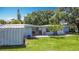 Private backyard featuring a spacious wooden deck, lush lawn, and convenient storage shed at 301 Oregon Ave, St Cloud, FL 34769