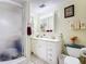 Bathroom features a double sink vanity and a walk-in shower at 301 Oregon Ave, St Cloud, FL 34769