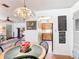 Cozy dining area with a decorative chandelier adjacent to the kitchen and living room at 301 Oregon Ave, St Cloud, FL 34769