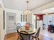 Cozy dining area with a round table, four chairs, and a chandelier overhead at 301 Oregon Ave, St Cloud, FL 34769