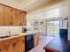 Functional kitchen features wood cabinets, laminate countertop, and a view into the dining area at 301 Oregon Ave, St Cloud, FL 34769