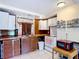 The kitchen has a retro charm, featuring wood countertops, white cabinets, and open shelving for spices and essentials at 301 Oregon Ave, St Cloud, FL 34769