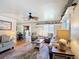 Relaxing living room showcases a ceiling fan, hardwood floors, and a plush rug at 301 Oregon Ave, St Cloud, FL 34769