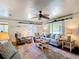 Bright living room features a ceiling fan, comfortable seating, and ample natural light at 301 Oregon Ave, St Cloud, FL 34769