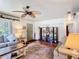 Spacious living room features hardwood floors, a ceiling fan, and stylish furnishings at 301 Oregon Ave, St Cloud, FL 34769