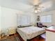 The main bedroom features a ceiling fan, neutral paint and wood floors at 301 Oregon Ave, St Cloud, FL 34769
