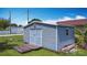 Outdoor shed with double doors and a small window providing additional storage space on the property at 301 Oregon Ave, St Cloud, FL 34769