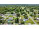 Overhead shot of a well-established neighborhood, revealing a mix of homes, verdant trees, and quiet streets at 3173 Wake Up Ct, Kissimmee, FL 34744