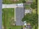 Birds eye view of a home with a large yard, outdoor patio, mature trees, and an RV at 3173 Wake Up Ct, Kissimmee, FL 34744