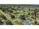 Scenic aerial view showcases a peaceful residential neighborhood with mature trees and well-maintained streets at 3173 Wake Up Ct, Kissimmee, FL 34744
