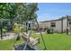 A wooden swing in a backyard with a patio dining set at 3173 Wake Up Ct, Kissimmee, FL 34744