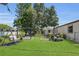 Lush backyard with a wooden swing, grill, patio, and lawn mower at 3173 Wake Up Ct, Kissimmee, FL 34744