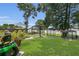 Grassy backyard features a lawn mower, grill, and outdoor patio set at 3173 Wake Up Ct, Kissimmee, FL 34744