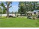 Spacious backyard with lush green lawn, swing, grill, and patio set at 3173 Wake Up Ct, Kissimmee, FL 34744
