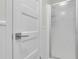 White bathroom with a glass shower stall and a white paneled door at 3173 Wake Up Ct, Kissimmee, FL 34744