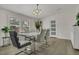 Dining room with a sleek table, modern chairs, and large windows for ample natural light at 3173 Wake Up Ct, Kissimmee, FL 34744