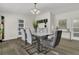 Modern dining room with stylish white table, seating for six, and elegant decor at 3173 Wake Up Ct, Kissimmee, FL 34744