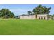 Inviting single-story home features a well-manicured lawn, and a bright yellow front door at 3173 Wake Up Ct, Kissimmee, FL 34744