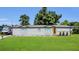 Well-maintained home exterior with a green lawn and orange front door at 3173 Wake Up Ct, Kissimmee, FL 34744