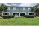 Back exterior view with a lawn, shrubbery, and patios with screen doors at 3664 Wilshire Way Rd # 261, Orlando, FL 32829