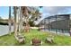 View of the backyard including a lawn, play set, and chairs near the enclosed pool at 3901 Ballinore Pl, Gotha, FL 34734