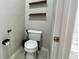 Bathroom featuring a toilet, stylish shelves, and hardware at 3901 Ballinore Pl, Gotha, FL 34734