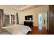 Bedroom with hardwood floors, access to an outdoor balcony, and a mounted television at 3901 Ballinore Pl, Gotha, FL 34734