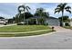Single story home featuring a well manicured lawn and mature landscaping with palm trees at 3901 Ballinore Pl, Gotha, FL 34734