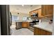 Functional kitchen with stainless steel appliances, wood cabinets, and white countertops at 3901 Ballinore Pl, Gotha, FL 34734