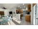 Open floor plan with a modern kitchen, breakfast bar, and adjacent living area at 3901 Ballinore Pl, Gotha, FL 34734