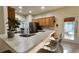 Bright kitchen featuring a breakfast bar, stainless steel refrigerator, and wooden cabinetry at 3901 Ballinore Pl, Gotha, FL 34734
