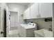 Laundry room features cabinetry above a front-load washer and dryer at 3901 Ballinore Pl, Gotha, FL 34734