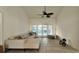 Cozy living room area with a comfortable couch, bench, and access to a screened in pool area at 3901 Ballinore Pl, Gotha, FL 34734