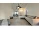 Spacious living room featuring large tile flooring, a comfortable couch, and a dining room at 3901 Ballinore Pl, Gotha, FL 34734
