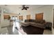 Spacious living room with sectional sofa and kitchen view, featuring tile floors and natural light at 3901 Ballinore Pl, Gotha, FL 34734