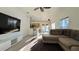 Bright living room with a breakfast bar, tile flooring, and a view of the kitchen at 3901 Ballinore Pl, Gotha, FL 34734