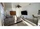 Comfortable living room with sectional sofa, tile floors, and a large screen TV at 3901 Ballinore Pl, Gotha, FL 34734