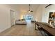 Open concept living space with access to screened-in patio and view to kitchen area at 3901 Ballinore Pl, Gotha, FL 34734