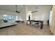 Open living space with large windows and access to both a dining room and screened-in pool area at 3901 Ballinore Pl, Gotha, FL 34734