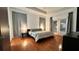 Bright main bedroom featuring hardwood floors, neutral decor, and a door to the outside at 3901 Ballinore Pl, Gotha, FL 34734