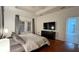 Main bedroom with wood floors, a TV, and access to the outside at 3901 Ballinore Pl, Gotha, FL 34734