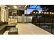 Patio area with couches, table, tv, and an enclosed pool with a childproof fence at 3901 Ballinore Pl, Gotha, FL 34734