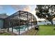 A sparkling pool with a screened enclosure and a grassy backyard are highlights of this outdoor space at 3901 Ballinore Pl, Gotha, FL 34734