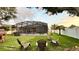 A spacious screened-in pool area provides the perfect place to relax or entertain while overlooking the manicured lawn at 3901 Ballinore Pl, Gotha, FL 34734