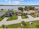 Aerial view of homes with waterfront views and community docks on a sunny day, with green lawns at 3991 Island Lakes Dr, Winter Haven, FL 33881