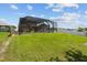 Spacious backyard features an inviting screened-in pool area, and ample green space at 3991 Island Lakes Dr, Winter Haven, FL 33881