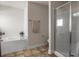 This bathroom features a soaking tub, a glass-enclosed shower, tile flooring, and towel rack at 3991 Island Lakes Dr, Winter Haven, FL 33881