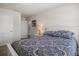 The bedroom boasts a white bed frame with dark paisley bedding, a door, and a lamp at 3991 Island Lakes Dr, Winter Haven, FL 33881